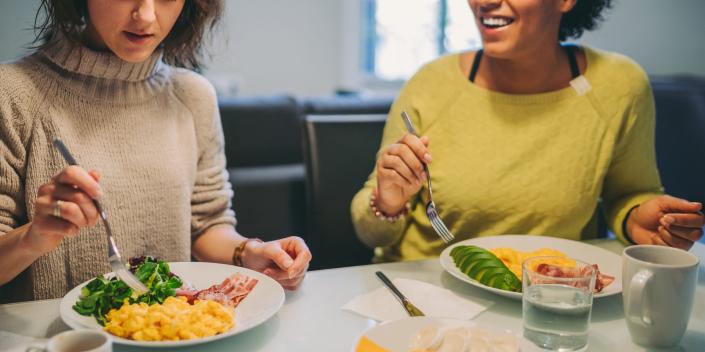 Two women eating keto food.