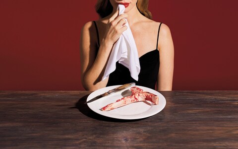 A woman eating meat