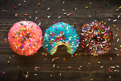 three donuts with frosting and sprinkles