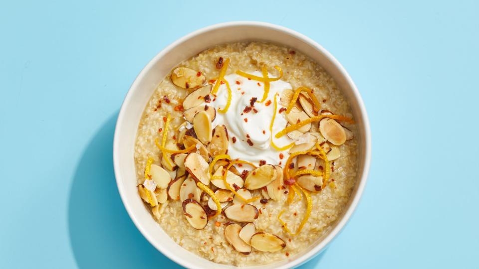 oatmeal with yogurt and toasted almonds on a blue background