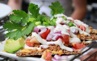 chopped vegetables and avocados on crackers