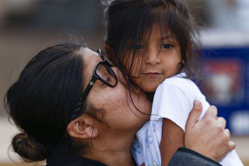 La Tiendita volunteer Gabrielle Castro kisses her daughter, Celeste, 5, after she comes by...