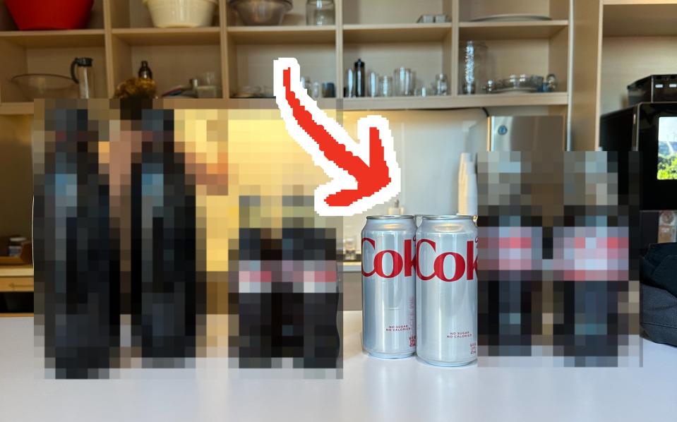 the four different types of diet coke lined up on a table with an arrow pointing to the can