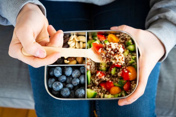 A woman eating a healthy lunch