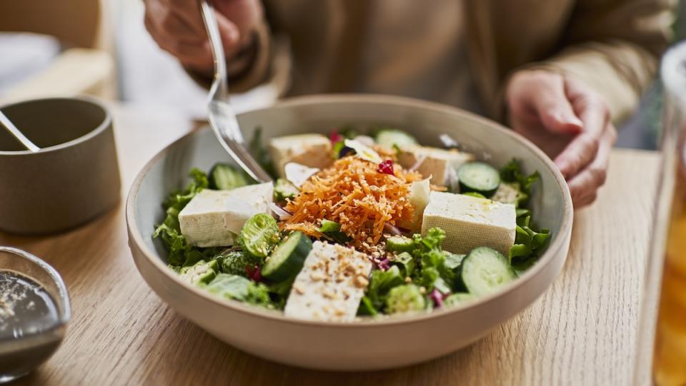 Woman eating a tofu salad