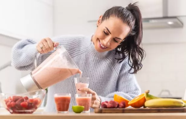 Woman blending fruit