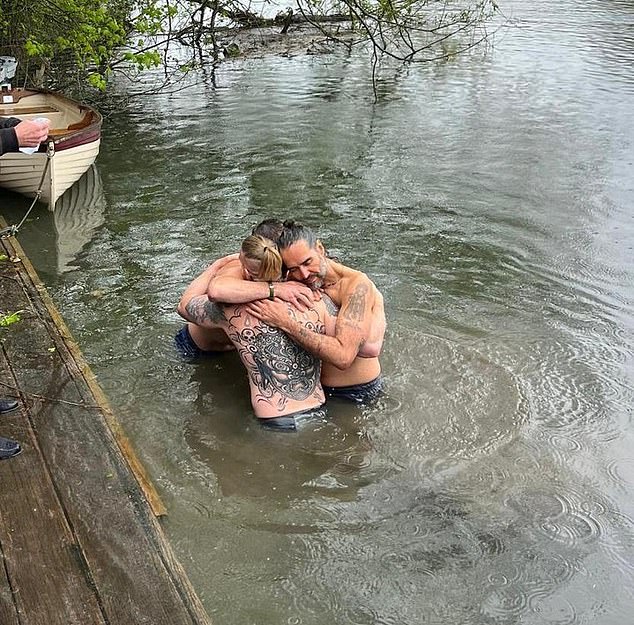 Grylls pictured taking part in a baptism ceremony for Russell Brand in the Thames (pictured)