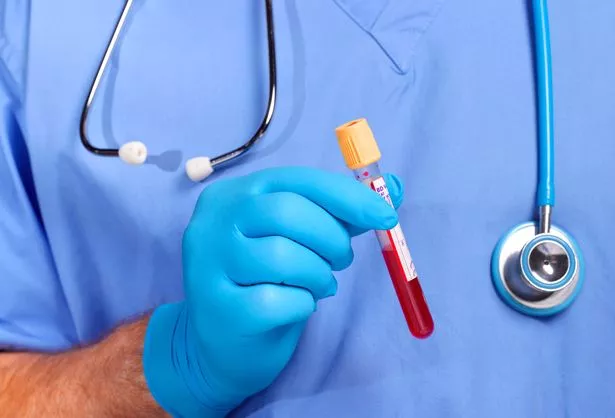 Doctor in scrubs doing blood test