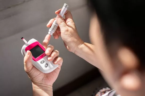 A person with diabetes measuring his insulin level at home