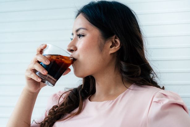 Woman drinking cola